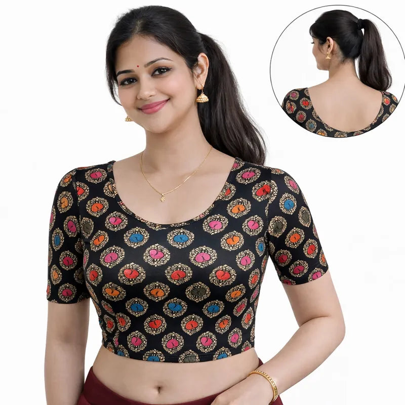 Woman wearing a black blouse with colorful patterns, with a close-up inset of the neckline.